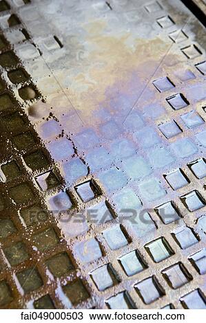 Motor oil in water puddle on ground View Large Photo Image Stock Image - Motor oil in water puddle on ground. Fotosearch
