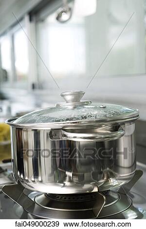 Pot cooking on stove View Large Photo Image Stock Photo - Pot cooking on stove. Fotosearch