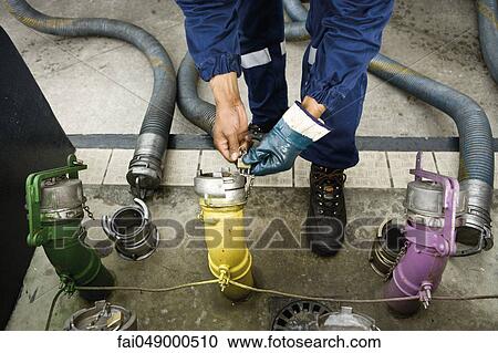 Stock Image - Preparing to fill gas station fuel storage tanks. Fotosearch