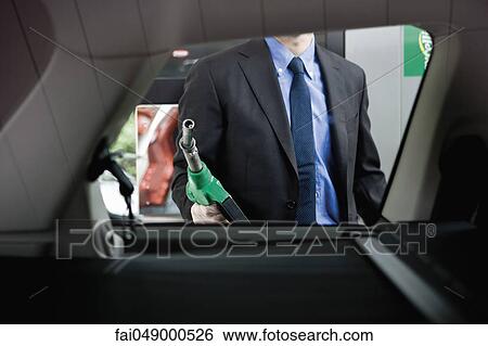 Preparing to refuel car at gas station View Large Photo Image Stock Photograph - Preparing to refuel car at gas station. Fotosearch