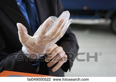 Putting on disposable gloves preparing to refuel vehicle View Large Photo Image Stock Image - Putting on disposable gloves preparing to refuel vehicle. Fotosearch