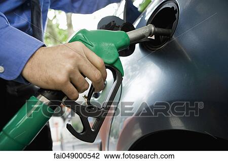 Stock Image - Refueling vehicle at gas station. Fotosearch