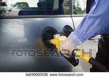 Refueling vehicle at gas station View Large Photo Image Stock Photo - Refueling vehicle at gas station. Fotosearch