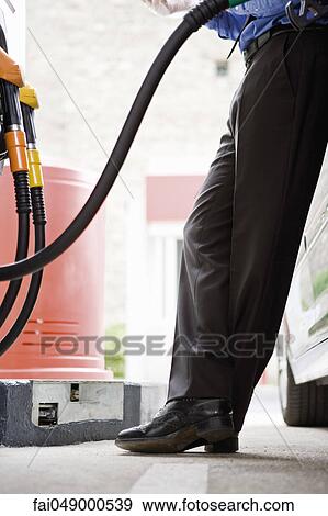 Refueling vehicle at gas station View Large Photo Image Stock Photo - Refueling vehicle at gas station. Fotosearch