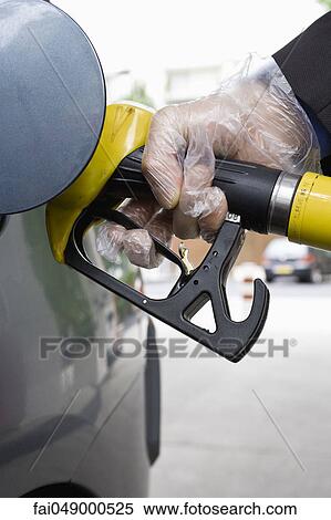 Refueling vehicle, wearing disposable glove View Large Photo Image Stock Photography - Refueling vehicle, wearing disposable glove. Fotosearch
