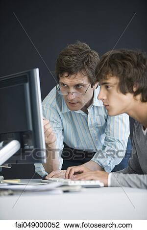 Student and teacher using computer together View Large Photo Image Stock Image - Student and teacher using computer together. Fotosearch