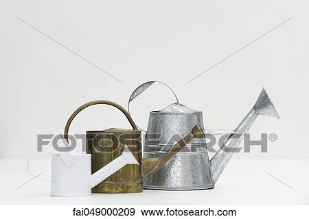 Stock Photo - Watering cans of various sizes. Fotosearch