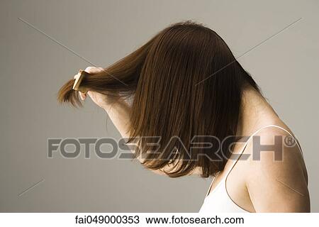 Woman combing hair View Large Photo Image Stock Image - Woman combing hair. Fotosearch