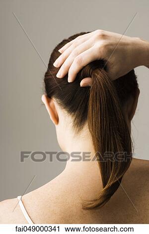 Woman styling hair, rear view View Large Photo Image Stock Image - Woman styling hair, rear view. Fotosearch