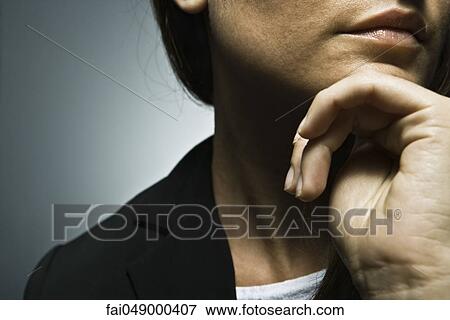 Woman with hand under chin, cropped View Large Photo Image Stock Photo - Woman with hand under chin, cropped. Fotosearch