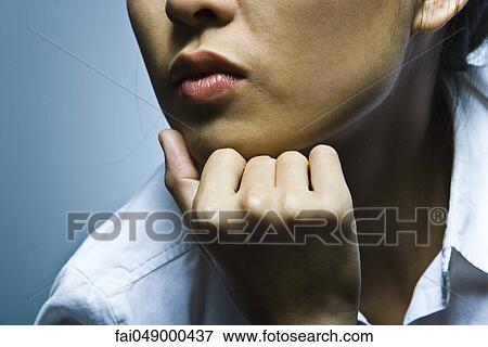 Woman with hand under chin contemplatively looking away View Large Photo Image Stock Photo - Woman with hand under chin contemplatively looking away. Fotosearch