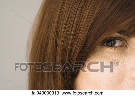 Young brunette woman looking at camera, cropped View Large Photo Image Stock Image - Young brunette woman looking at camera, cropped. Fotosearch