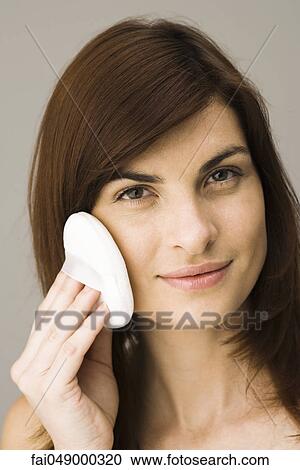 Young woman applying facial powder View Large Photo Image Stock Image - Young woman applying facial powder. Fotosearch