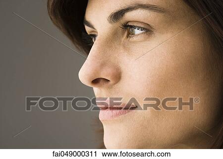 Young woman contemplatively looking away View Large Photo Image Stock Image - Young woman contemplatively looking away. Fotosearch