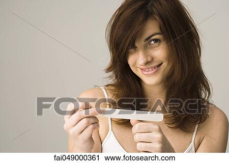 Young woman filing nails View Large Photo Image Stock Image - Young woman filing nails. Fotosearch