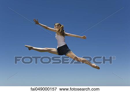 Young woman leaping, midair View Large Photo Image Stock Photo - Young woman leaping, midair. Fotosearch