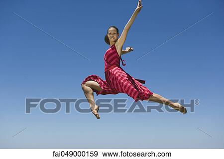 Young woman leaping, midair View Large Photo Image Stock Photo - Young woman leaping, midair. Fotosearch
