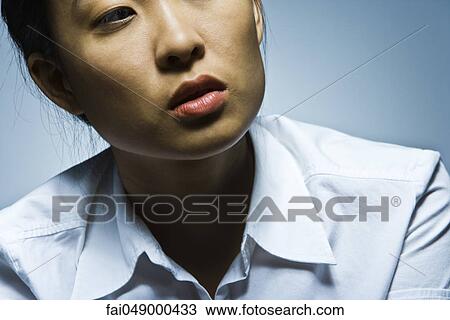 Young woman looking around with air of curiosity View Large Photo Image Stock Image - Young woman looking around with air of curiosity. Fotosearch
