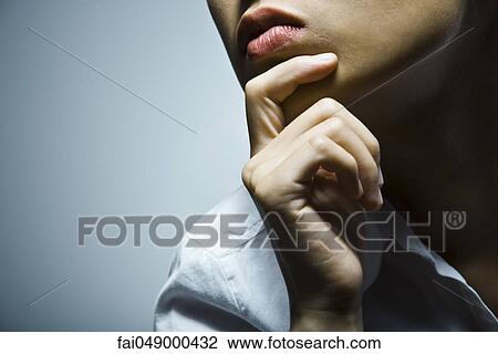 Young woman with hand under chin, cropped View Large Photo Image Stock Image - Young woman with hand under chin, cropped. Fotosearch