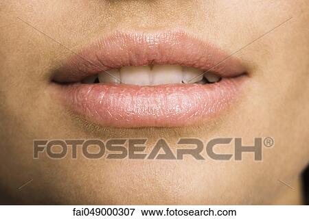 Stock Photo - Young woman's mouth, close-up. Fotosearch