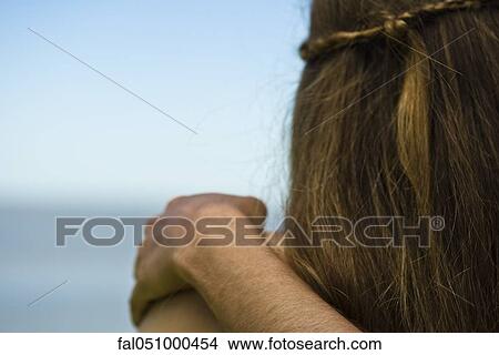 Picture - Arm around shoulder, looking at view. Fotosearch