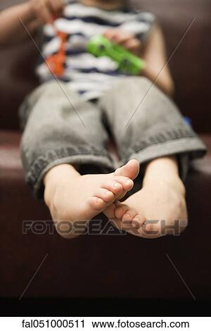 Barefoot child playing with toys View Large Photo Image Stock Image - Barefoot child playing with toys. Fotosearch