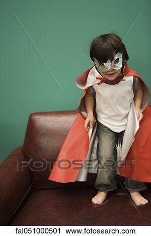 Boy in costume standing on sofa View Large Photo Image Stock Image - Boy in costume standing on sofa. Fotosearch