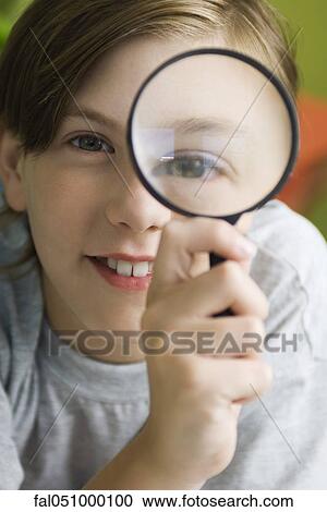 Boy looking through magnifying glass View Large Photo Image Stock Image - Boy looking through magnifying glass. Fotosearch
