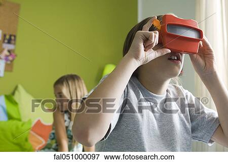 Boy looking through toy viewfinder View Large Photo Image Stock Photo - Boy looking through toy viewfinder. Fotosearch