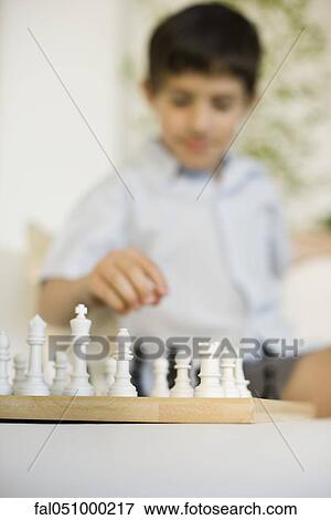 Boy playing chess View Large Photo Image Stock Photo - Boy playing chess. Fotosearch