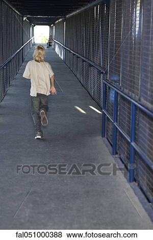 Boy running down corridor, rear view View Large Photo Image Stock Photo - Boy running down corridor, rear view. Fotosearch