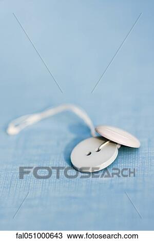 Stock Image - Buttons threaded together. Fotosearch