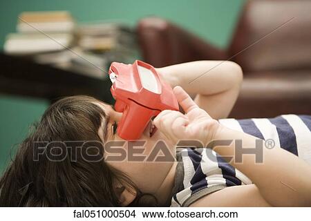 Child looking through toy viewfinder View Large Photo Image Picture - Child looking through toy viewfinder. Fotosearch