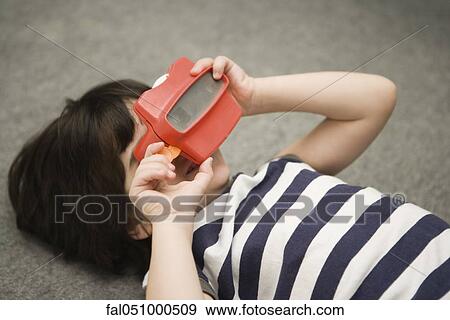 Child looking through toy viewfinder View Large Photo Image Stock Photo - Child looking through toy viewfinder. Fotosearch