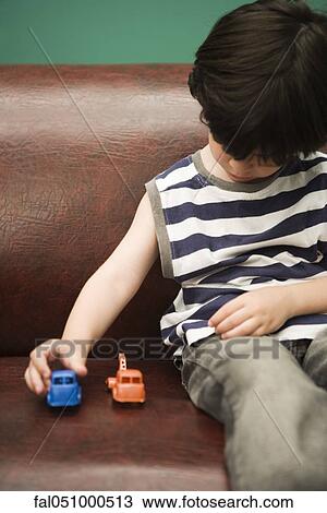 Child playing with toy cars View Large Photo Image Stock Image - Child playing with toy cars. Fotosearch