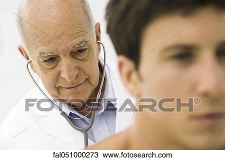 Doctor conducting medical exam View Large Photo Image Stock Image - Doctor conducting medical exam. Fotosearch