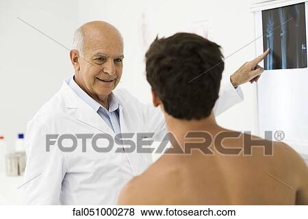 Doctor explaining x-ray to patient View Large Photo Image Stock Photo - Doctor explaining x-ray to patient. Fotosearch
