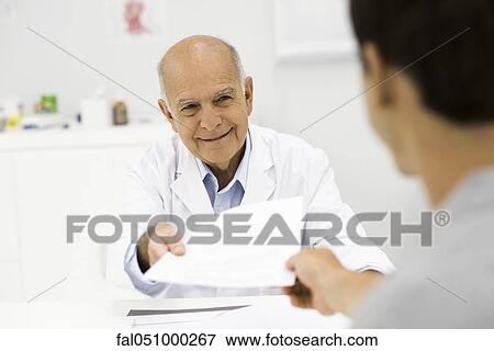 Stock Photo - Doctor handing document to patient. Fotosearch