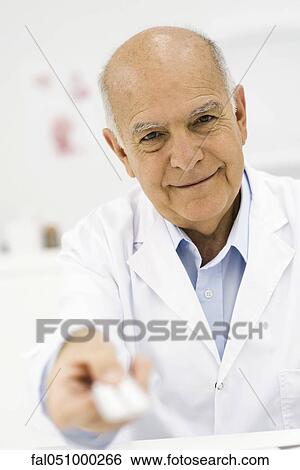 Doctor handing prescription medicine to patient, personal perspective View Large Photo Image Stock Photograph - Doctor handing prescription medicine to patient, personal perspective. Fotosearch