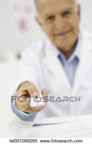 Doctor holding out prescription medication, personal perspective View Large Photo Image Stock Photography - Doctor holding out prescription medication, personal perspective. Fotosearch