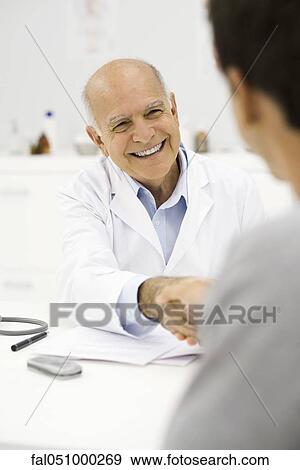 Doctor shaking patient's hand View Large Photo Image Stock Photo - Doctor shaking patient's hand. Fotosearch