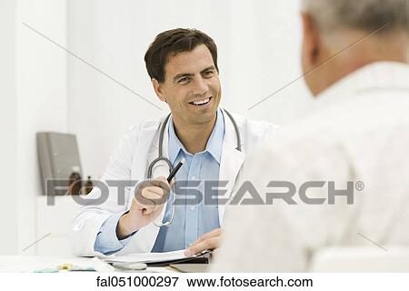 Doctor with senior patient providing medical consultation View Large Photo Image Stock Photo - Doctor with senior patient providing medical consultation. Fotosearch
