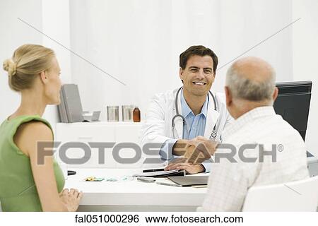 Doctor with senior patient providing medical consultation View Large Photo Image Stock Photograph - Doctor with senior patient providing medical consultation. Fotosearch