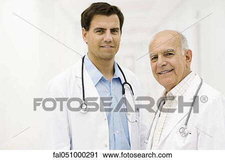 Stock Image - Doctors together in hospital corridor, portrait. Fotosearch