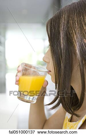 Drinking glass of orange juice View Large Photo Image Stock Photo - Drinking glass of orange juice. Fotosearch