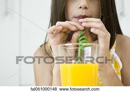 Stock Photo - Drinking juice through curly straw. Fotosearch