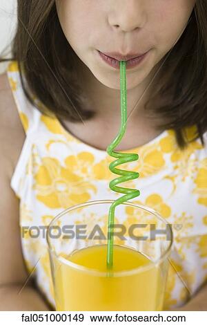 Stock Photo - Drinking juice through curly straw. Fotosearch