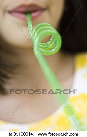 Stock Photo - Drinking through curly straw. Fotosearch