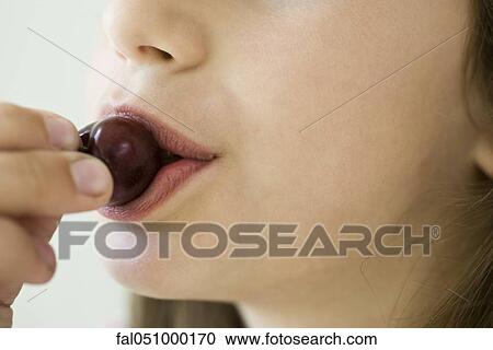 Eating cherry, close-up View Large Photo Image Stock Image - Eating cherry, close-up. Fotosearch