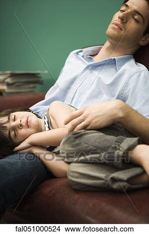 Father and son napping together on sofa View Large Photo Image Picture - Father and son napping together on sofa. Fotosearch